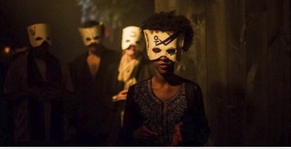 Masked performers in a dim corridor at the Unknown 9 launch in New York