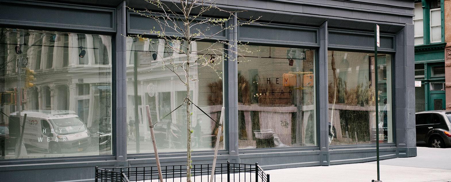 The Heywear storefront on a Manhattan street, the wordmark visible through the window