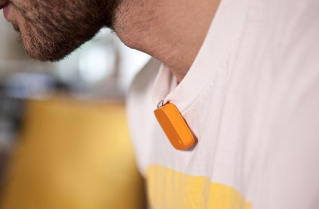 The orange Narrative Clip camera worn on a shirt
